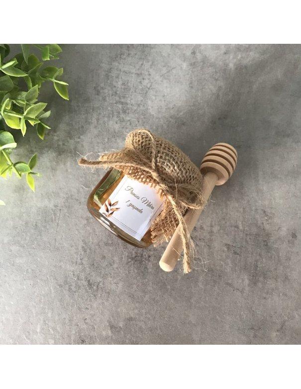 Petit pot de miel avec cuillère en bois